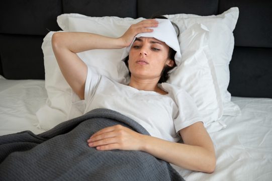 Medium shot sick woman laying in bed