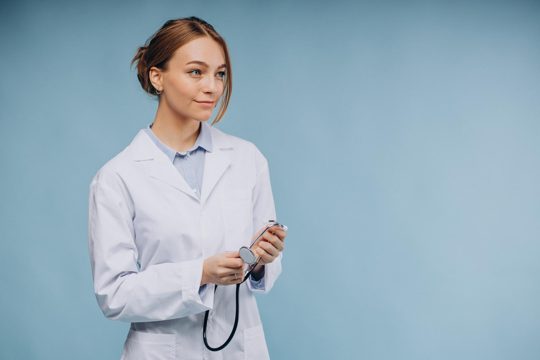 Woman doctor wearing lab coat with stethoscope isolated