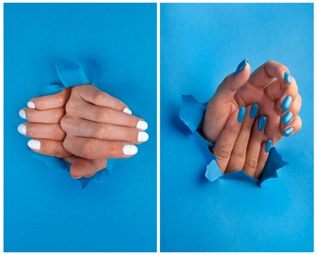 Hands with blue and white nails