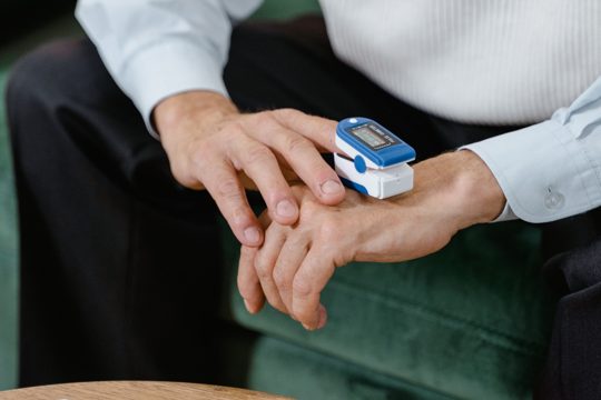 A Person Using a Pulse Oximeter