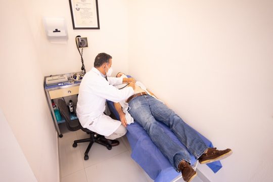 Man in White Dress Shirt and Blue Denim Jeans Sitting on Black Office Rolling Chair