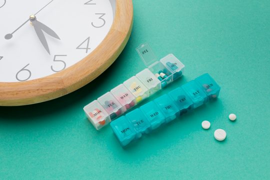 Close-up clock and daily pills