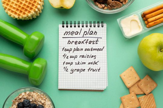 Meal planning notepad and food assortment