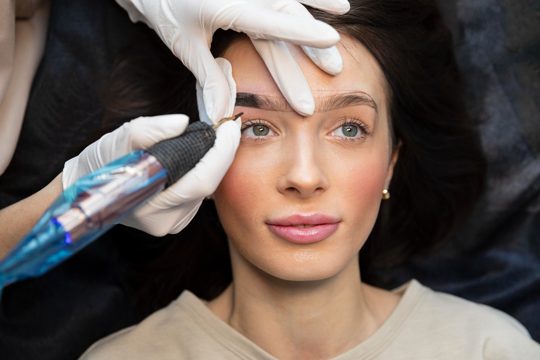 Young woman getting a beauty treatment for her eyebrows