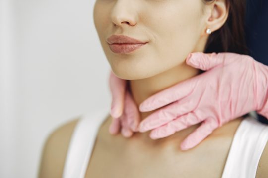 Woman with a doctor in cosmetology studio